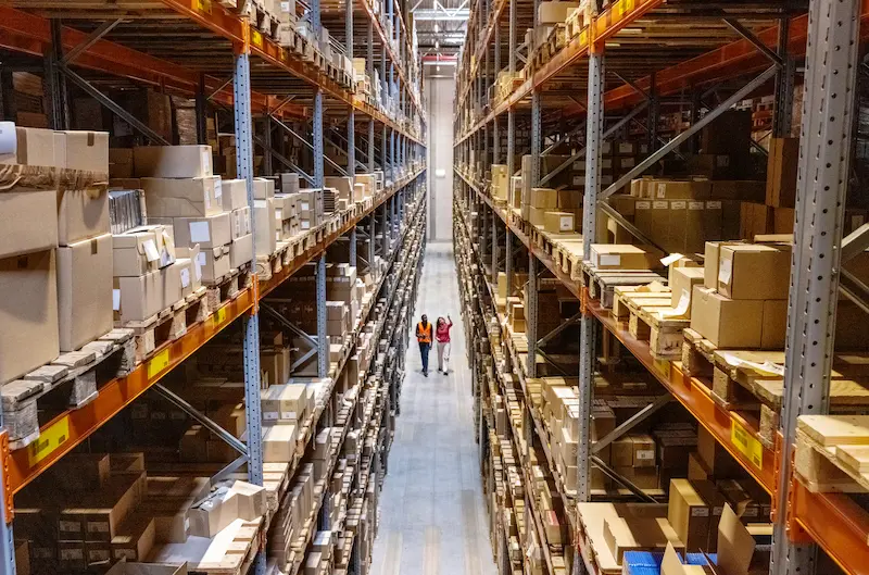 Interior of a large warehouse with tall shelves stacked with cardboard boxes in Orlando, FL